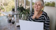 Beautiful Senior Woman Using Laptop At Home. Mature Smiling Woman