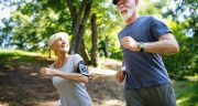 Mature Or Senior Couple Doing Sport Outdoors, Jogging In A Park